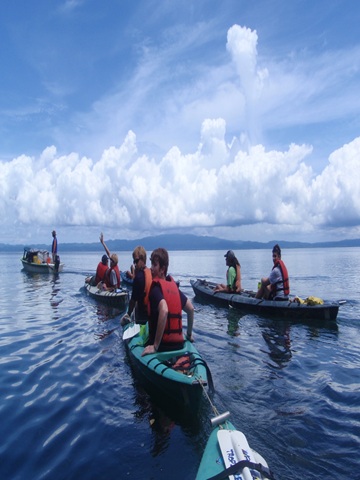Canoes on a lake with mountains